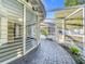 Covered walkway leads to a screened-in pool area with tropical foliage and privacy at 905 W 11Th Ave, Mount Dora, FL 32757