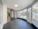 Light-filled sunroom with curved windows offers a unique architectural detail and serene view of the backyard at 905 W 11Th Ave, Mount Dora, FL 32757