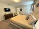 Relaxing bedroom featuring plush king bed, dresser with TV, and neutral decor for a serene retreat at 9055 Dogleg Dr, Davenport, FL 33896