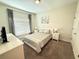 Cozy bedroom featuring natural light, plush queen bed, and minimalistic decor for a tranquil retreat at 9055 Dogleg Dr, Davenport, FL 33896