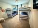 ' bedroom with two sets of bunkbeds with blue comforters and carpeted flooring at 9055 Dogleg Dr, Davenport, FL 33896