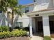 Inviting entrance to townhome with a landscaped walkway, stylish planters and welcoming doorway at 9055 Dogleg Dr, Davenport, FL 33896