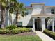 Inviting townhome exterior with tropical landscaping and a well-manicured lawn at 9055 Dogleg Dr, Davenport, FL 33896