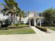 Charming townhome showcasing a well-maintained exterior with mature trees and lush landscaping at 9055 Dogleg Dr, Davenport, FL 33896
