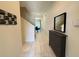 Bright hallway with tiled floors, leading to a dining area and staircase at 9055 Dogleg Dr, Davenport, FL 33896