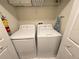 Bright laundry area with two large, white washing machines at 9055 Dogleg Dr, Davenport, FL 33896