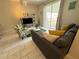 Cozy living room with modern furnishings and serene views of outdoor area at 9055 Dogleg Dr, Davenport, FL 33896