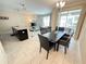 Open-concept living space featuring a dining table, modern lighting, and a stylish kitchen island at 9055 Dogleg Dr, Davenport, FL 33896