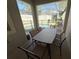 Enclosed patio with six chairs around a table next to the pool at 9055 Dogleg Dr, Davenport, FL 33896