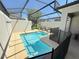 The screened-in pool area features a built-in spa and ample patio space for relaxing and entertaining at 9055 Dogleg Dr, Davenport, FL 33896