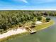 Scenic aerial view of a community park with a beach, playground, pier, and walking paths by the water at 997 Lake Berkley Dr, Kissimmee, FL 34746
