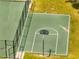 Aerial view of a fenced green basketball court with freshly painted lines, ready for play at 997 Lake Berkley Dr, Kissimmee, FL 34746
