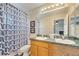 Bright bathroom features double sinks with a decorative shower curtain and an attached open bedroom space at 997 Lake Berkley Dr, Kissimmee, FL 34746