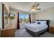 Comfortable bedroom featuring a ceiling fan, television, window and natural light at 997 Lake Berkley Dr, Kissimmee, FL 34746
