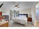 Comfortable bedroom features a ceiling fan, a crib and natural light at 997 Lake Berkley Dr, Kissimmee, FL 34746