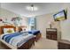 Bedroom with two beds, ceiling fan, mounted tv, wall art and natural light at 997 Lake Berkley Dr, Kissimmee, FL 34746