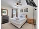 Comfortable bedroom features a ceiling fan, dresser and mounted television at 997 Lake Berkley Dr, Kissimmee, FL 34746