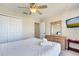 Bedroom with a ceiling fan, double door closet, dresser and natural light at 997 Lake Berkley Dr, Kissimmee, FL 34746