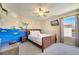 Bedroom featuring a ceiling fan, wall art, mounted tv and natural light at 997 Lake Berkley Dr, Kissimmee, FL 34746