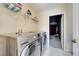 The laundry room has tiled floors, washer and dryer units, and lots of storage at 997 Lake Berkley Dr, Kissimmee, FL 34746