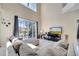 Bright living room with tile floors, a high ceiling and direct access to the screened pool at 997 Lake Berkley Dr, Kissimmee, FL 34746