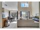 Open-concept living room with tile floors, high ceilings, and sliding glass doors to the outdoor pool area at 997 Lake Berkley Dr, Kissimmee, FL 34746