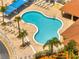 Aerial view of a stylish pool with palm trees and lounge chairs, perfect for relaxation and leisure at 997 Lake Berkley Dr, Kissimmee, FL 34746