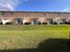 Townhome backyard features a well maintained lawn, sliding glass doors, and partial fencing at 10116 Shadow Leaf Ct, Orlando, FL 32825