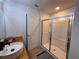 Modern bathroom features glass enclosed shower and white vessel sink at 10116 Shadow Leaf Ct, Orlando, FL 32825