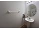 Clean half bath with pedestal sink, neutral tones and convenient towel bar at 10116 Shadow Leaf Ct, Orlando, FL 32825