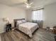 Bright bedroom featuring wood floors, a ceiling fan, and a window for plenty of natural light at 10116 Shadow Leaf Ct, Orlando, FL 32825