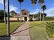 Community center with secure gate, stone path, lush landscaping, and palm tree lined walkway at 10116 Shadow Leaf Ct, Orlando, FL 32825