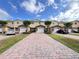 Townhomes feature brick driveways, attached garages, manicured lawns, and well-kept landscaping at 10116 Shadow Leaf Ct, Orlando, FL 32825