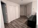 Hallway features laminate flooring, linen closet, and neutral paint at 10116 Shadow Leaf Ct, Orlando, FL 32825