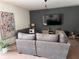 Comfortable living room features contemporary furnishings, a stylish accent wall, and natural light at 10116 Shadow Leaf Ct, Orlando, FL 32825