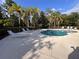 Community pool and lounge area featuring sun loungers surrounded by palm trees at 10116 Shadow Leaf Ct, Orlando, FL 32825