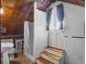 Attic bathroom with wood paneled ceiling, white beadboard paneling, and access to an exterior door at 1018 Jersey Ave, St Cloud, FL 34769