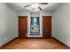 Bedroom with hardwood floors and trim, with window looking out to water at 1018 Jersey Ave, St Cloud, FL 34769