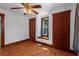 Bedroom featuring hardwood floors, natural light, and charming wood trim throughout at 1018 Jersey Ave, St Cloud, FL 34769