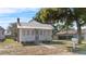 Charming cottage-style home featuring a new metal roof, brick chimney, and welcoming front porch at 1018 Jersey Ave, St Cloud, FL 34769
