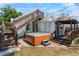 Outdoor hot tub on a brick patio with wooden steps and stairs leading to an upper-level deck at 1018 Jersey Ave, St Cloud, FL 34769