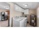 Spacious laundry room with modern appliances and storage cabinets at 1018 Jersey Ave, St Cloud, FL 34769