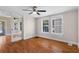 Charming living room with hardwood floors, large windows, and glass-paneled french doors to other rooms at 1018 Jersey Ave, St Cloud, FL 34769