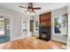 Living room with an electric fireplace, hardwood floors, and wooden accent trim at 1018 Jersey Ave, St Cloud, FL 34769