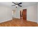 Bright living room featuring hardwood floors, white trim, and a modern ceiling fan with lights at 1018 Jersey Ave, St Cloud, FL 34769