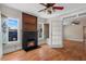 Living room with an electric fireplace, hardwood floors, and wooden accent trim at 1018 Jersey Ave, St Cloud, FL 34769