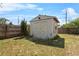 Backyard storage shed with double doors and white trim, surrounded by a wooden fence at 1018 Jersey Ave, St Cloud, FL 34769