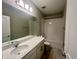 Clean bathroom with white vanity, sink and bathtub/shower with neutral tile, great for families at 12253 S Bracco St, Winter Garden, FL 34787