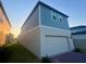 Two-story home featuring an attached two-car garage and low maintenance lawn at 12253 S Bracco St, Winter Garden, FL 34787