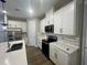 Beautiful kitchen with white cabinets, stainless steel appliances, sleek countertops, and modern tile backsplash at 12253 S Bracco St, Winter Garden, FL 34787
